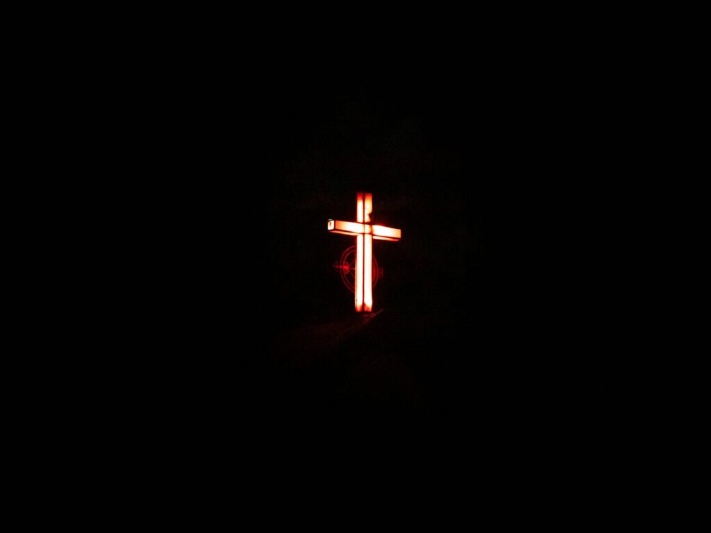 DAY 15 – THE PURPOSE OF SUFFERING Glowing cross against a dark background from Faisalabad, Pakistan.