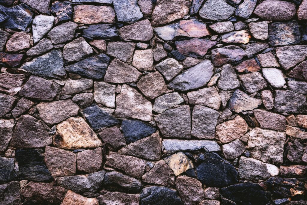 DAY 55 - THE WALLS OF JERICHO FELL High-resolution image of a rustic stone wall showing detailed texture and pattern.