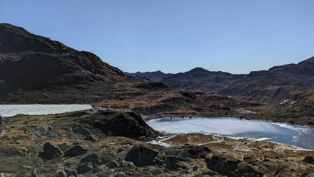 Breathtaking view of a frozen lake surrounded by mountains in Sikkim, India.