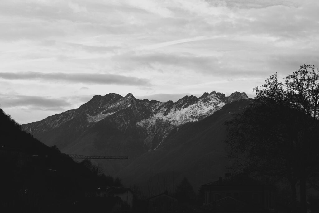 A stunning grayscale image of the Italian Alps in winter, captured in Bormio, Lombardia.