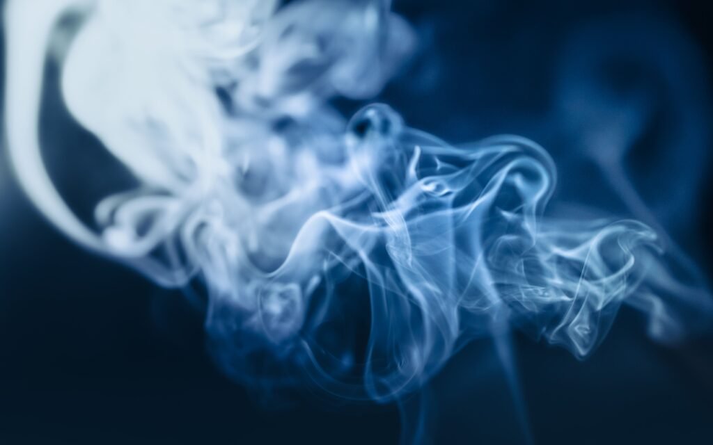 Abstract close-up of blue smoke swirls creating a mystical, ethereal effect.