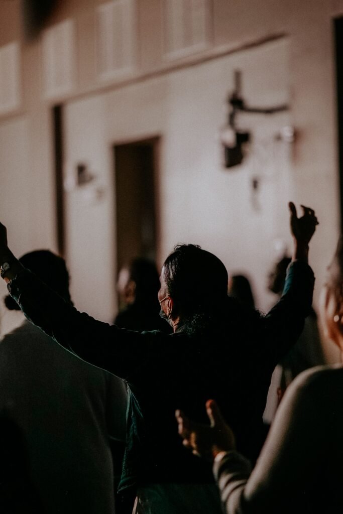 A devotional gathering with people in prayer, expressing faith and unity.
