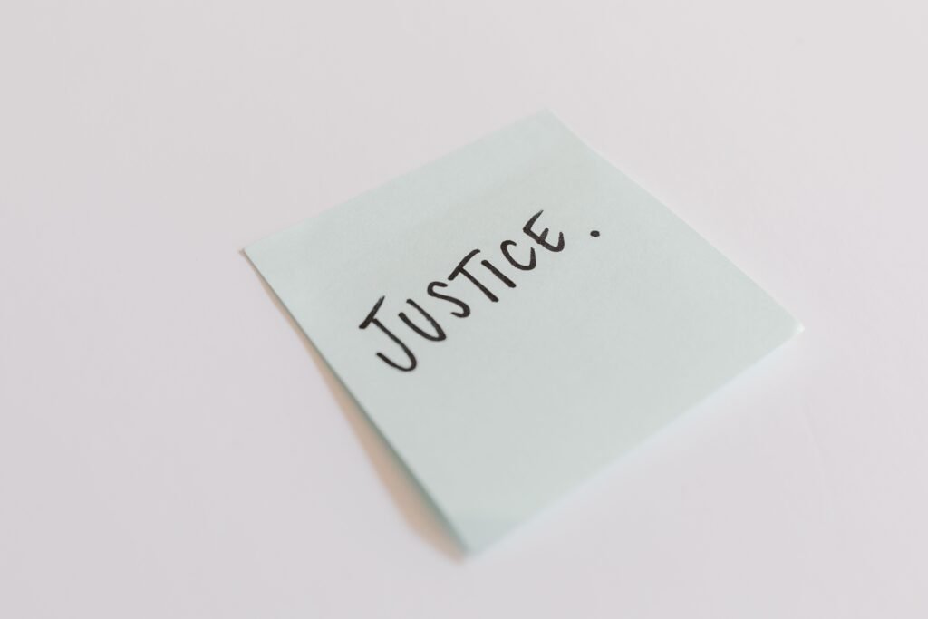 26 SEPTEMBER 2026, DAY 269 - GOD’s JUSTICE A close-up shot of a sticky note with the word 'Justice' handwritten on it.