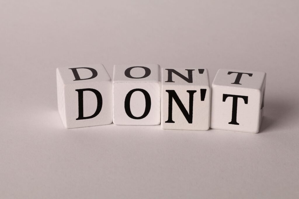 Text cubes spelling 'DON'T' on a clean white background, ideal for concepts of caution or prohibition.