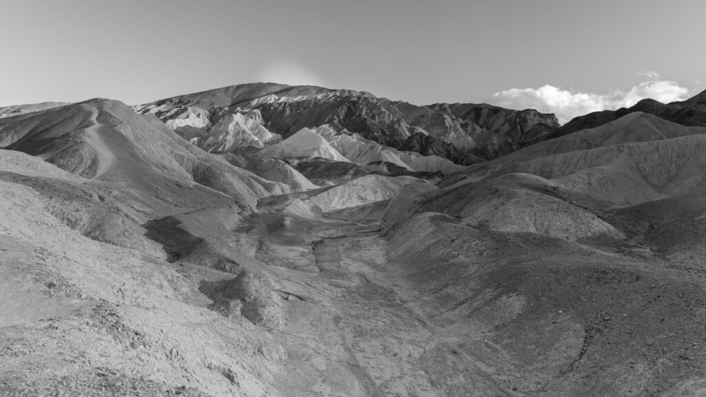 Majestic monochrome view of Death Valley's eroded landscape, showcasing rugged mountains and valleys.